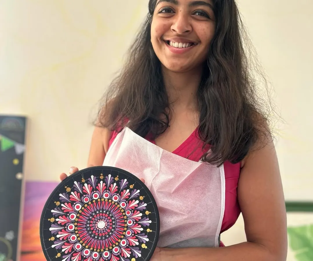 Look at that proud smile. This participant is holding her finished Dot Mandala plate, a beautiful and intricate piece she created dot by dot in one of my adult workshops.