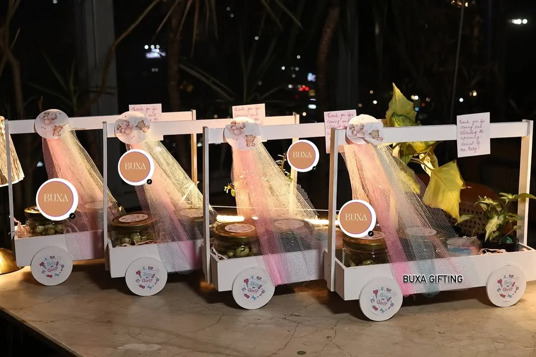 I had so much fun creating these luxury baby shower carts for a celebration in Gurgaon. Each custom white basket on wheels was filled with premium goodies like lemon masala makhanas, Theobroma cookies, and a ceramic bonsai planter to delight every guest.