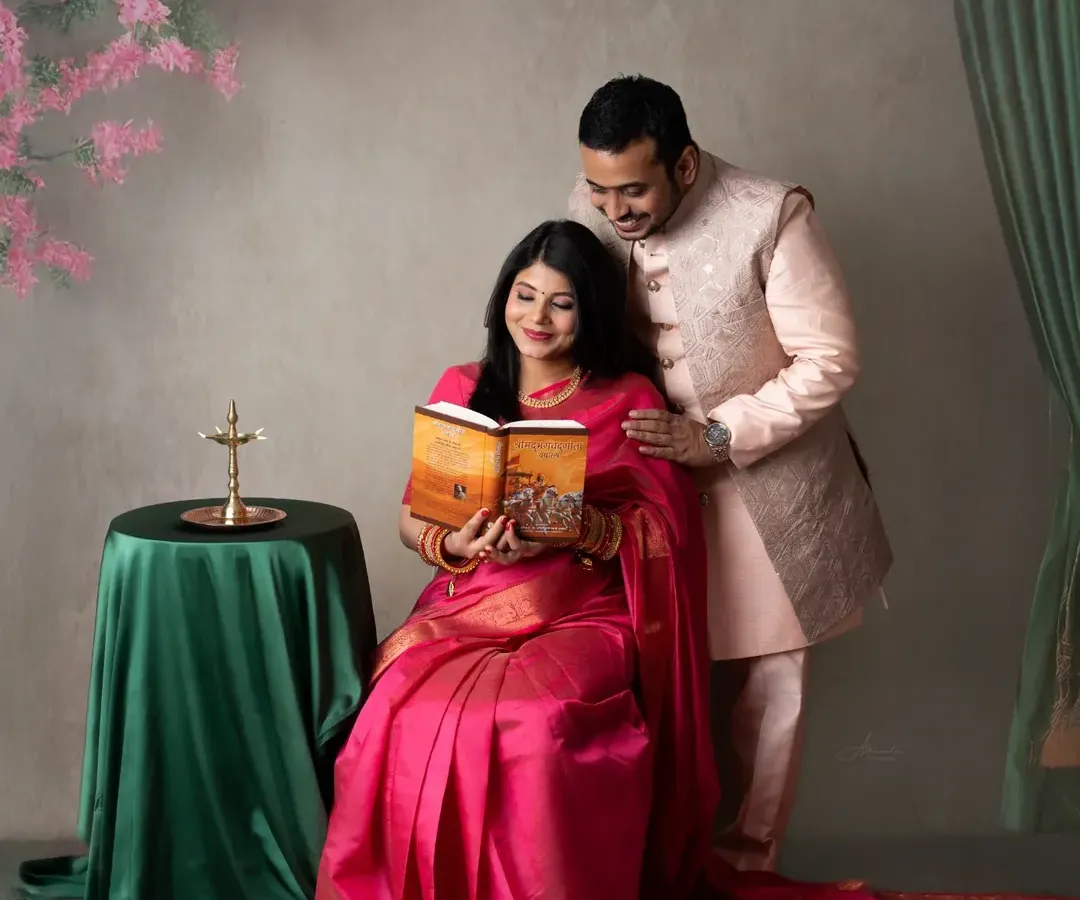 A portrait that feels like a timeless painting. We worked with this couple to create a traditional maternity look, using a vibrant pink saree and classic props like a brass lamp to celebrate their cultural roots.