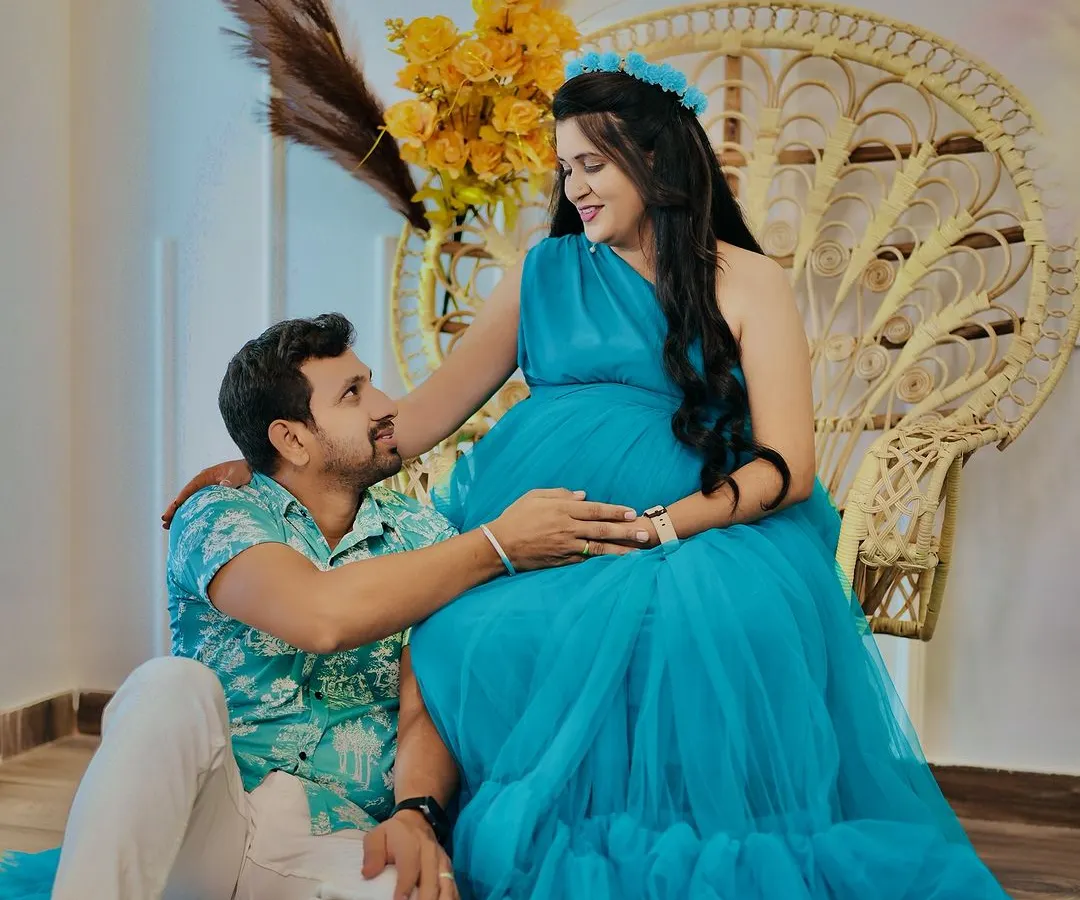 A quiet moment of connection between partners during their maternity shoot. Our popular boho-themed setup with the peacock chair provides a warm and relaxed backdrop for capturing these intimate memories.