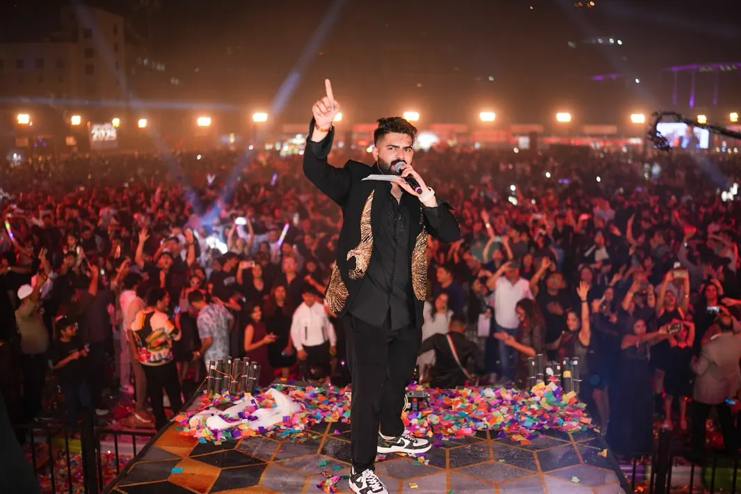 The incredible Mika Singh commands the stage, engaging with a massive, energetic crowd during the New Year's Eve concert. Our artist management and stage production services ensure a seamless and powerful performance every time.