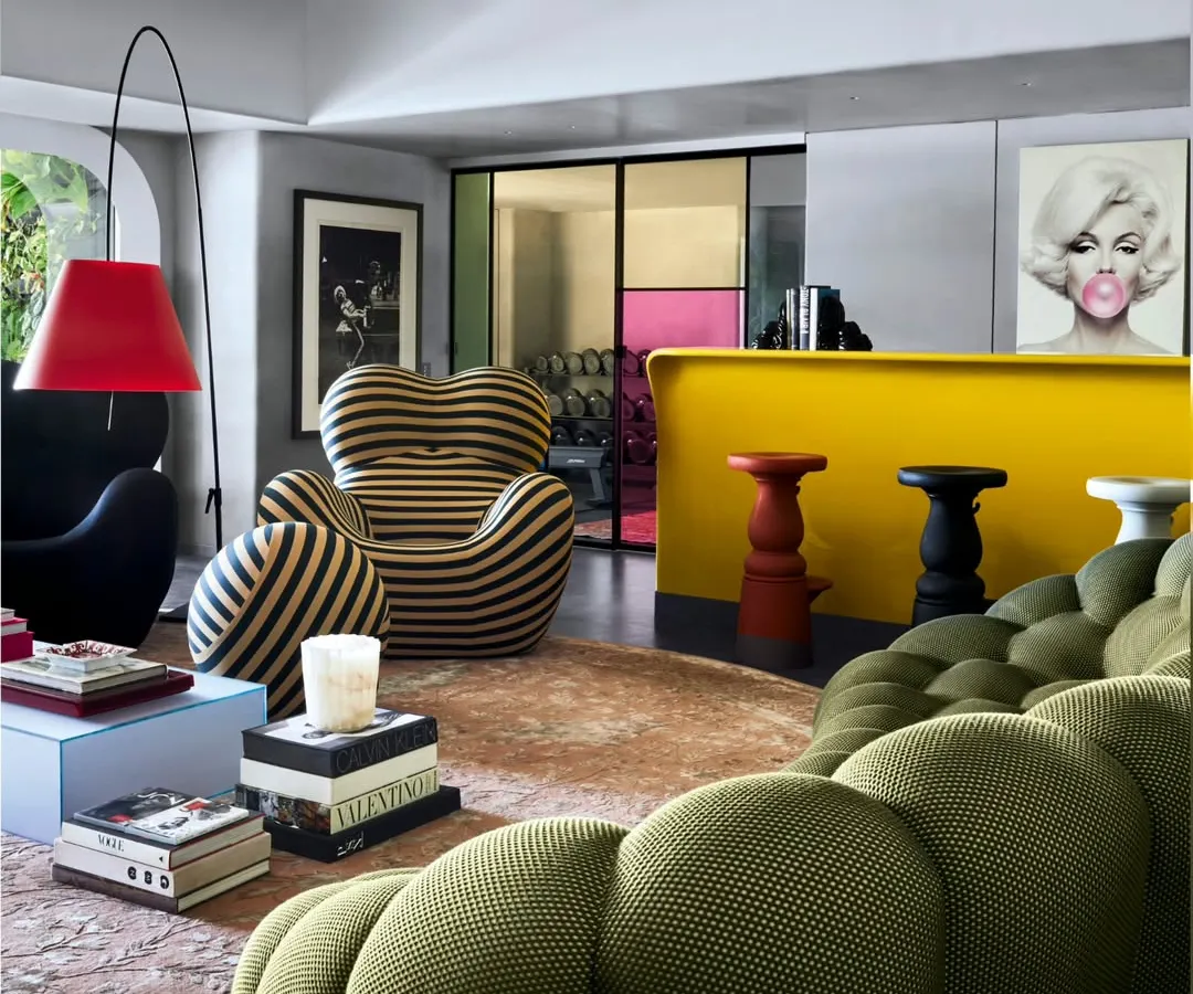 This is Project 86, a bachelor pad where we went all out. We mixed iconic pieces like the Roche Bobois Bubble couch with a bold yellow bar and pop art. This is how we create a living room that’s not just for living, but for making a statement.