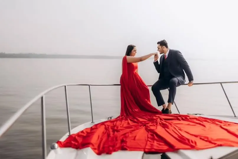 For a touch of glamour and romance, you can’t go wrong with a classic red gown. This infinity trail gown looks incredible on a yacht, creating those luxurious, cinematic shots you've always wanted.