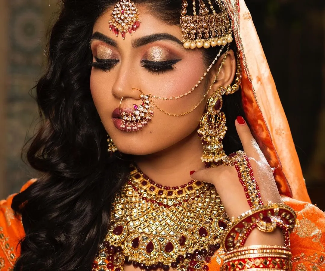 A classic North Indian bridal portrait. We focus on creating a flawless, radiant base and highlighting the eyes, complemented by traditional jewelry to complete the regal look.