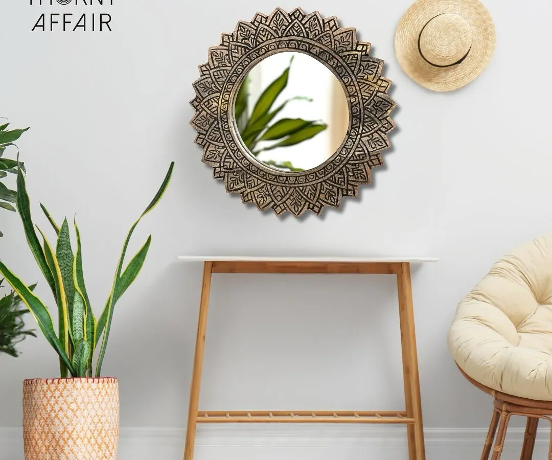 This is one of my favorite pieces, a sunburst-style mirror that brings so much warmth and texture to a room. Styled here in a cozy corner, it shows how a single piece of wall art can define the mood, blending beautifully with natural elements like plants and rattan.