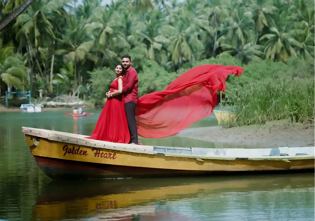 For this pre-wedding shoot, we used the beautiful Karavali coastline. The flowing red gown against the serene backwaters and the 'Golden Heart' boat created a truly cinematic and romantic photograph.