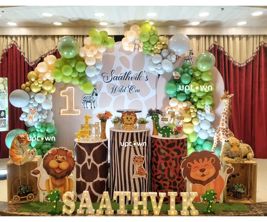 For this "Wild One" first birthday, I transformed the space into a vibrant jungle. The setup includes custom animal print pedestals, character cutouts of lions and zebras, and a lush balloon arch to create a fun safari adventure.