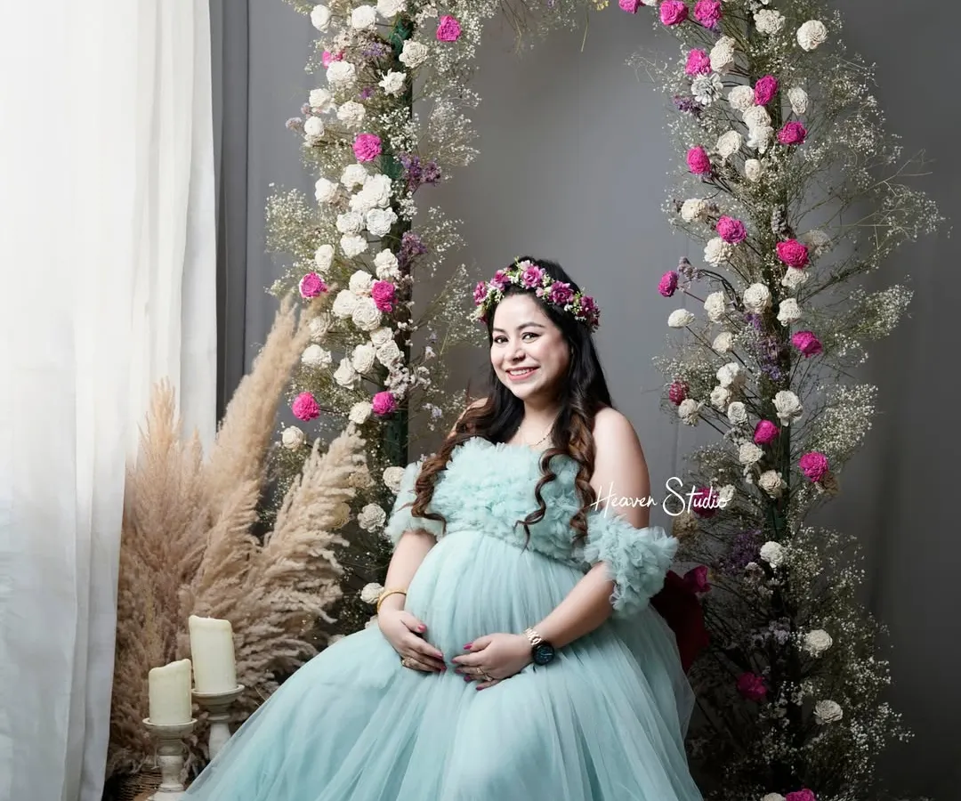 The radiant glow of motherhood deserves to be celebrated. In my Noida studio, I create dreamlike settings like this floral arch, using a stunning off-shoulder tulle gown from my collection to make you feel like the queen you are.