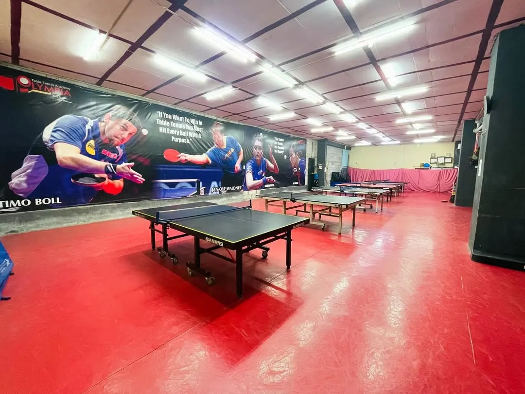 A look at our professional training hall. We have multiple high-quality tables and a floor designed for competitive play, giving you the space and setup needed to focus on your game.