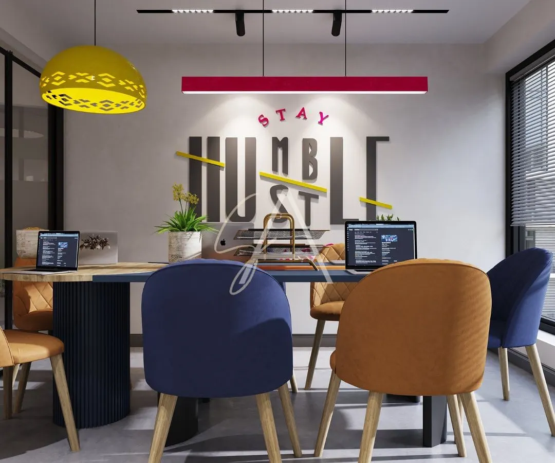 A glimpse into a modern office meeting room where creativity thrives. We used bold color accents, including a vibrant red light fixture and multi-colored chairs, against a backdrop of motivational wall graphics to create an energetic and collaborative workspace.