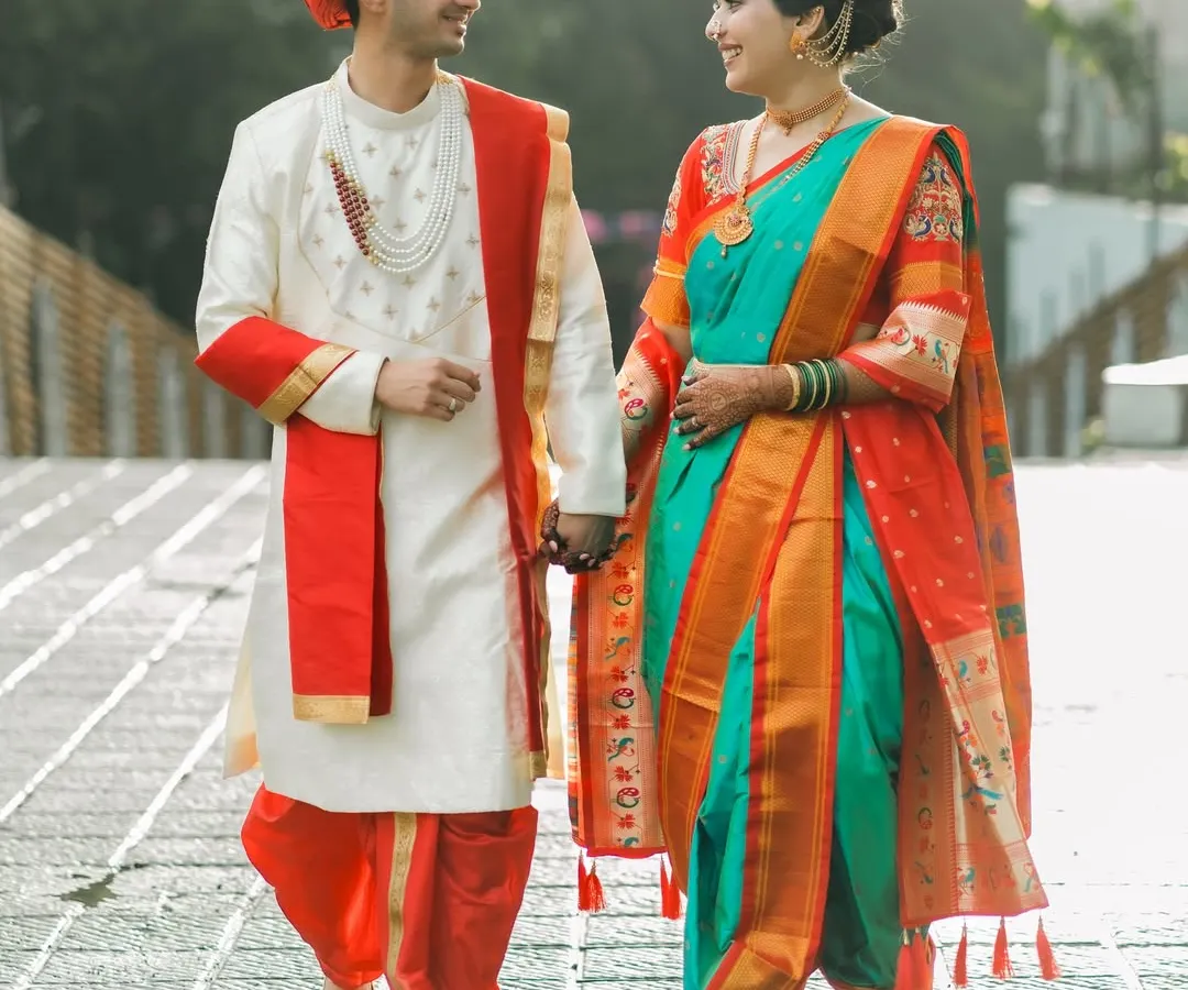 A beautiful Maharashtrian couple taking a stroll, hand in hand. We love capturing the elegance of the traditional Nauwari saree and the groom's vibrant attire.