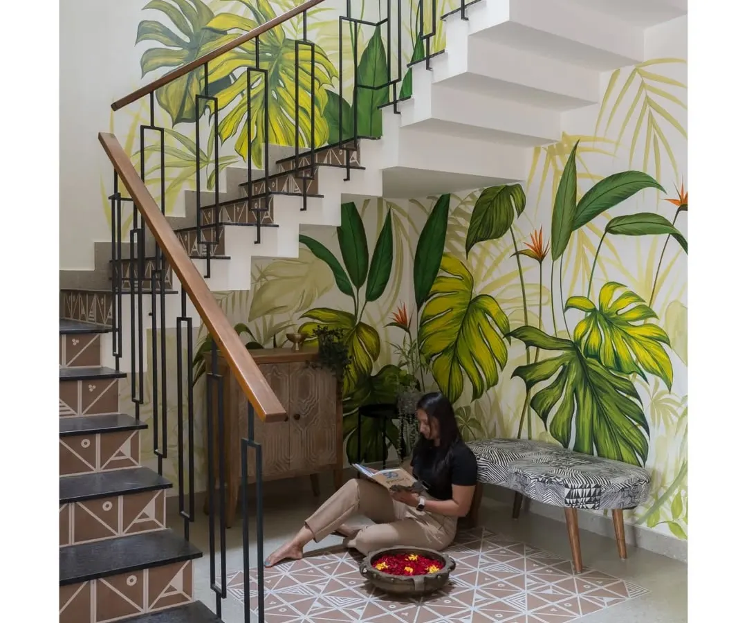 I believe every part of a home can be a piece of art. For this staircase, we commissioned a custom, hand-painted mural that turns a simple transition space into a vibrant, biophilic experience, bringing the tranquility of nature indoors.