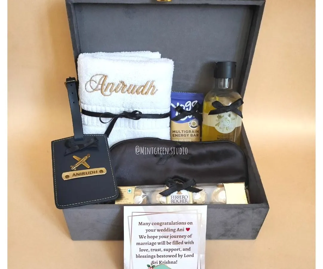 Finding the perfect gift for him can be tricky, but I love the challenge. This hamper, in a classy grey suede box, features a mix of practical and personal items, including an embroidered towel and a custom luggage tag for his travels.