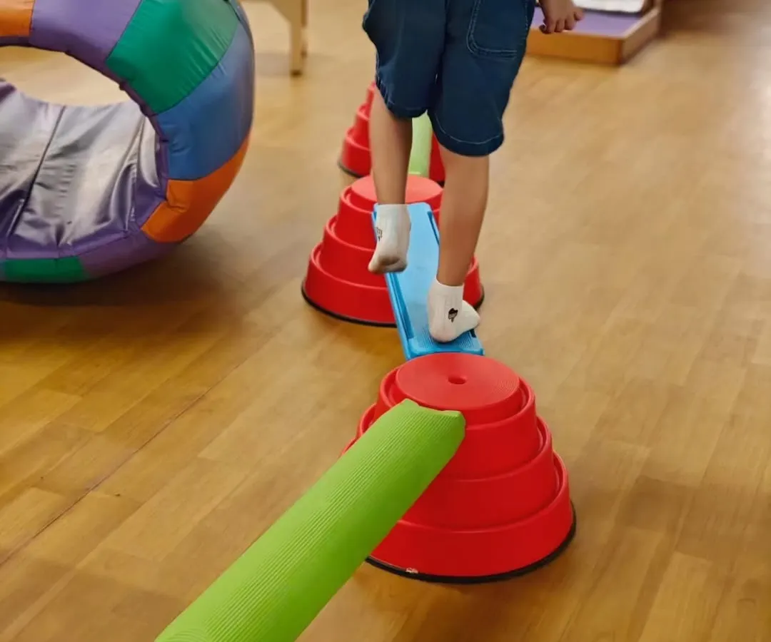 Occupational therapy can look like play, because that’s when children learn best. Here, a child navigates an obstacle course, building balance, coordination, and body awareness, which are foundational skills for focus and self-regulation in daily life.