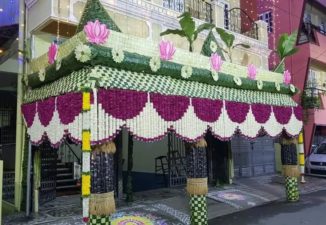 I construct authentic chappra entrances, like this grand version with intricate woven coconut leaf patterns, floral details, and lotus motifs, creating a truly sacred welcome.