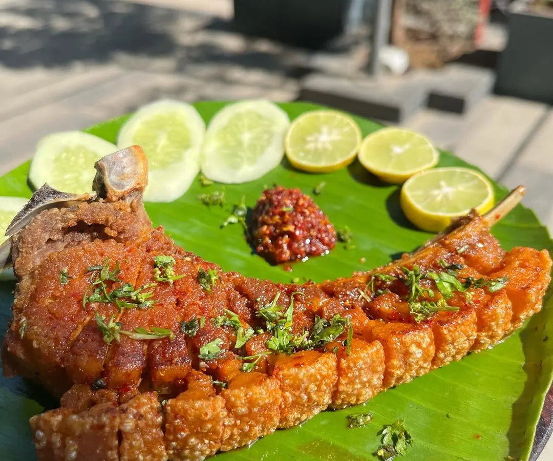Our Crispy Pork Ribs are a must try. We season a whole rack of ribs with Naga spices and fry it to perfection, leaving the skin incredibly crispy while the meat remains tender and juicy. It's served with fresh cucumber, lemon, and our house-made chili dip.