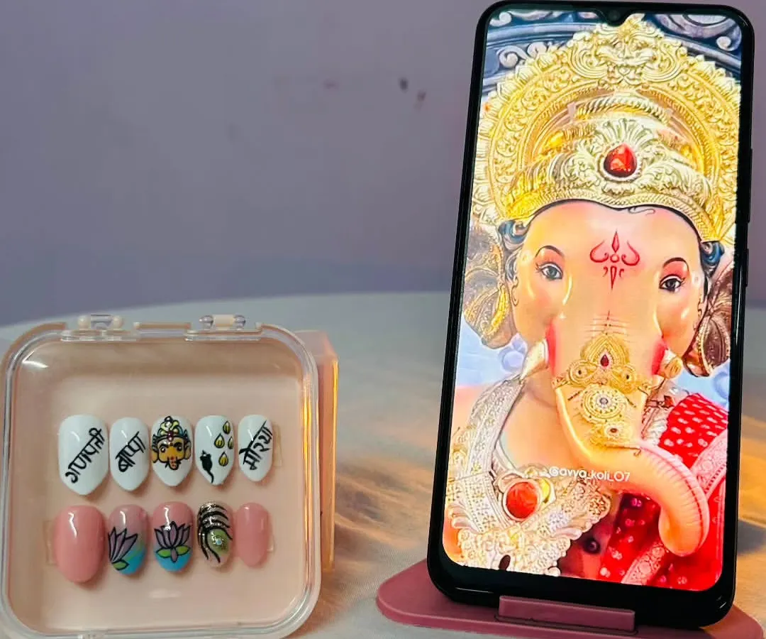 Creating these Ganpati-themed nails was a truly special experience. Each nail is hand-painted with details like a Ganesha portrait, lotus flowers, and auspicious symbols, making it a wearable piece of art for the festival.