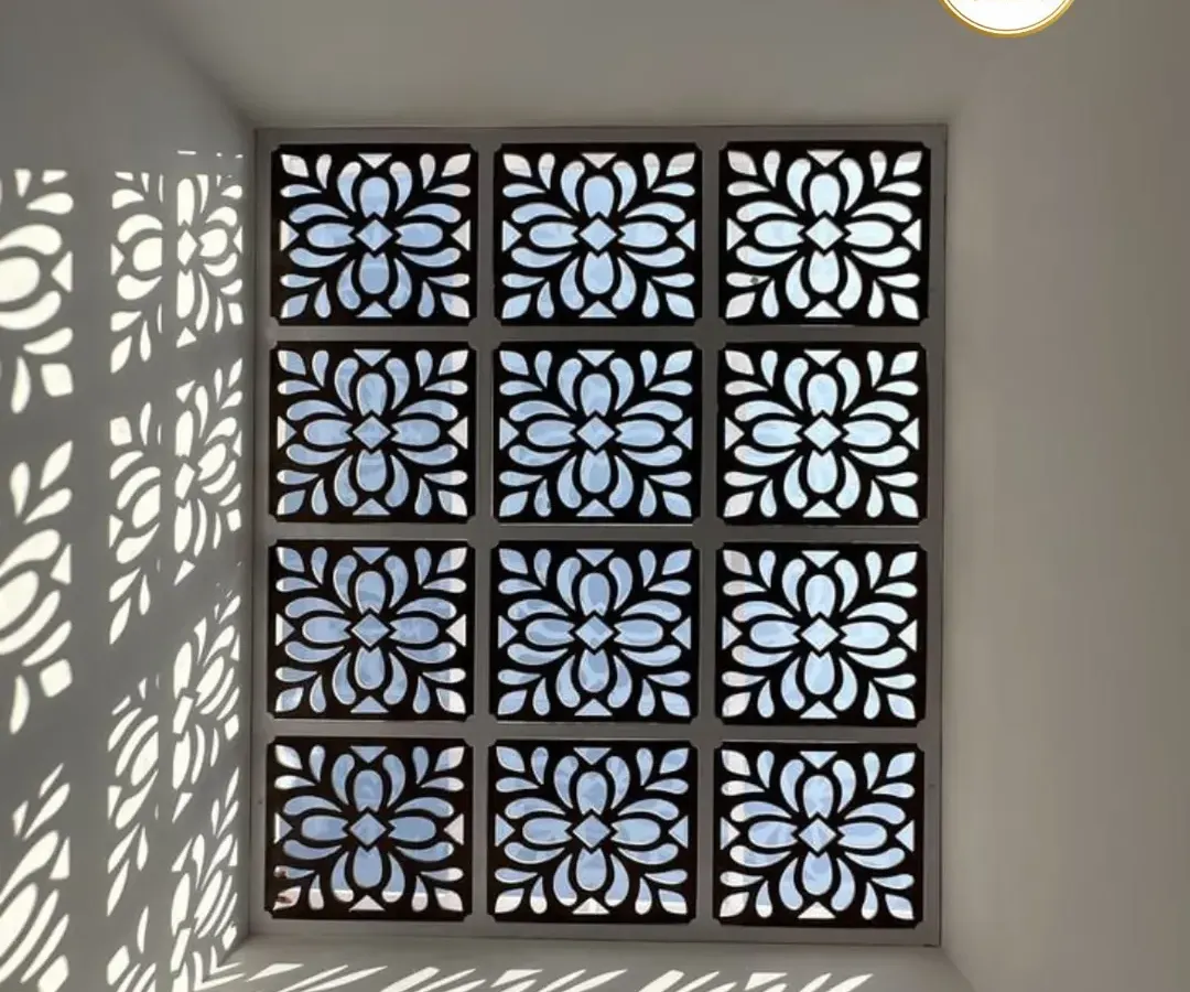 This is how we transform a simple ceiling into a captivating feature. We crafted this skylight using custom-cut panels in an ornate floral pattern, creating a dynamic play of light and shadow that shifts throughout the day and adds a layer of artistic elegance to the room below.