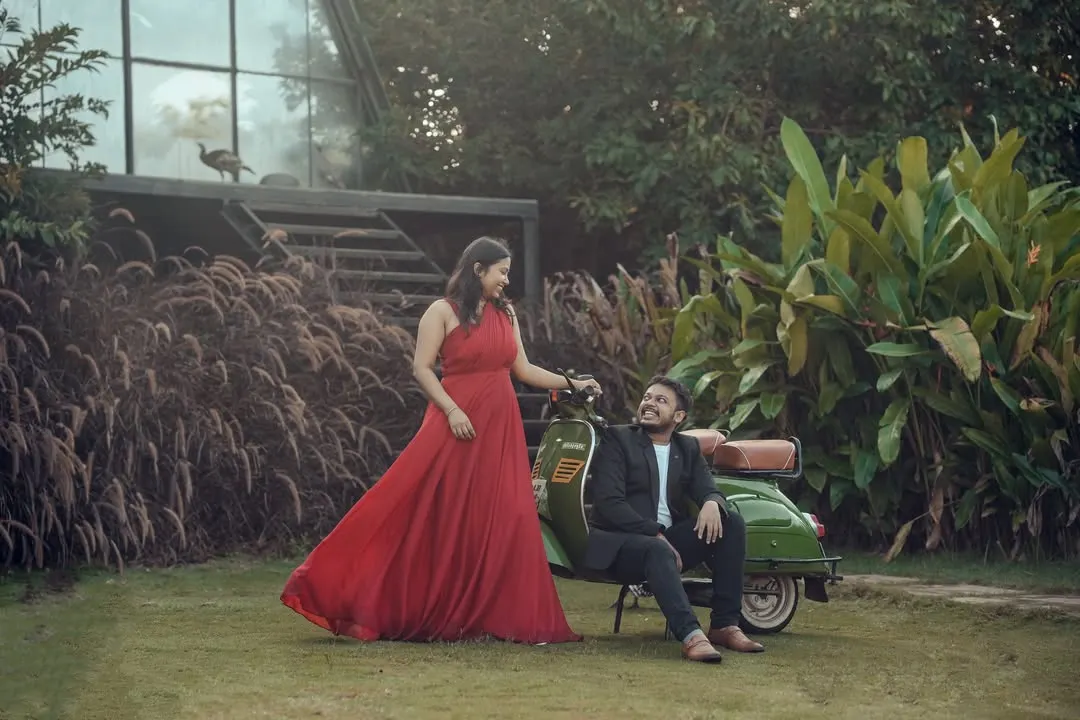 I create fun, vibrant memories with props like our vintage scooter. This couple's pre-wedding shoot in our lush garden set shows how we can match your outfits and personality to the perfect backdrop.