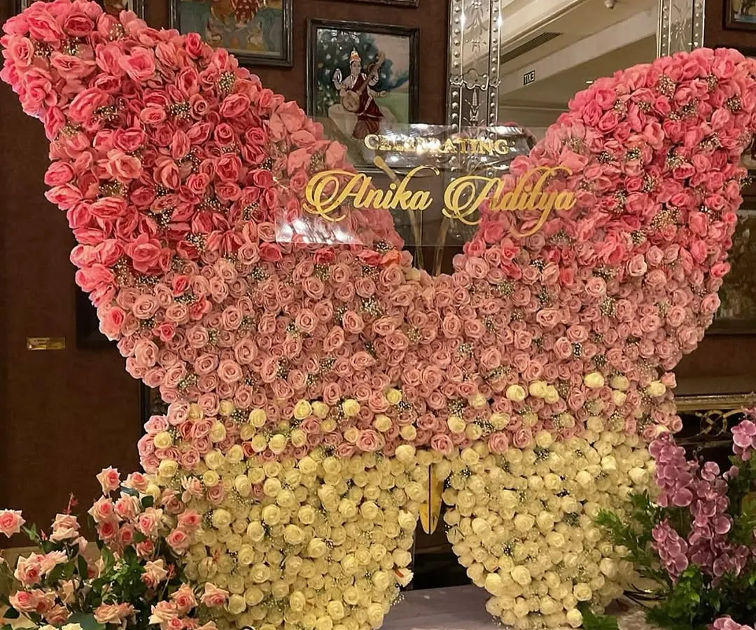 We crafted this breathtaking butterfly backdrop from hundreds of fresh pink and cream roses for a truly magical cradle ceremony. This statement piece creates a stunning focal point and a perfect photo opportunity, celebrating new life in the most beautiful way.