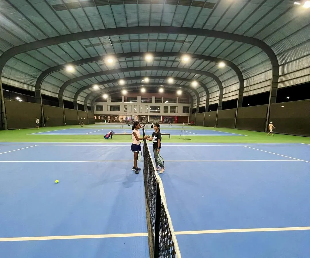 A wide view of our professional, covered hard courts during a UTR tournament. The state-of-the-art lighting and all-weather roofing ensure that training and competition can happen year-round, day or night.