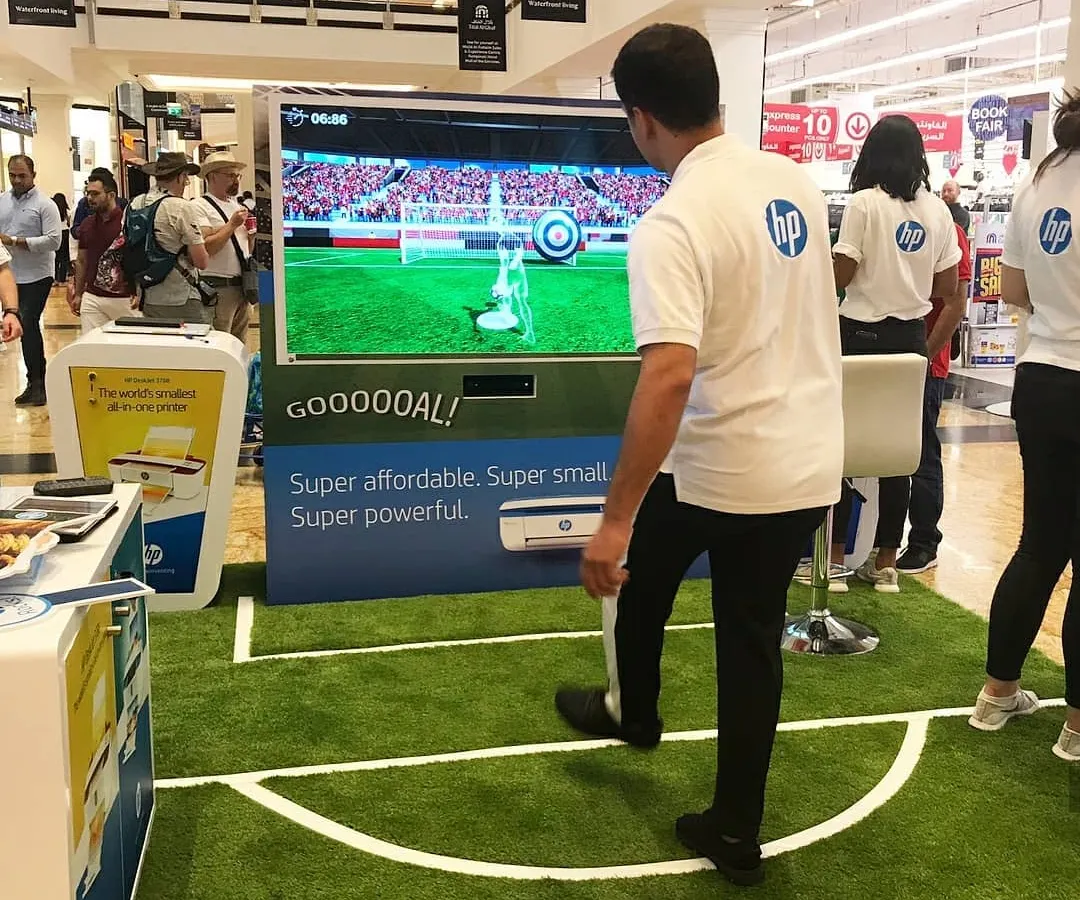 Here is our motion-sensing soccer game in action at an HP brand activation. Participants kick a real ball towards a large screen, where sensors track its speed and trajectory for a fun and competitive penalty shootout experience that draws a crowd.
