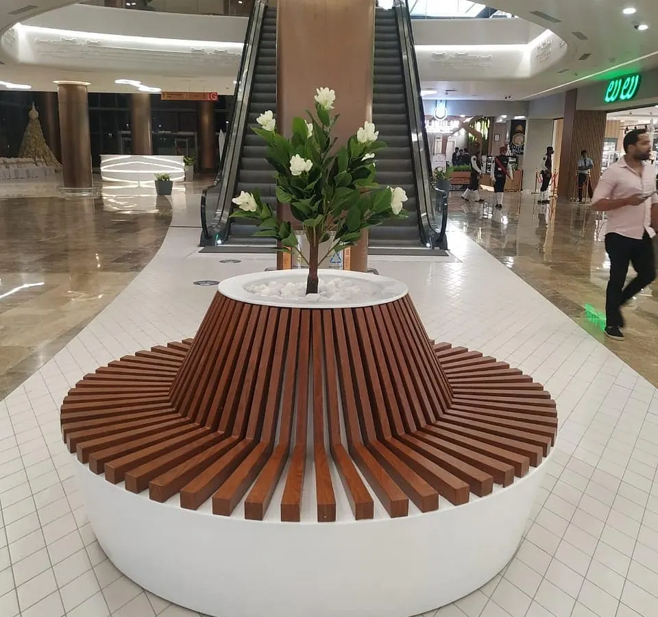 I love creating functional art, like this custom circular bench with an integrated planter at Lulu Hypermarket. It provides seating for shoppers while seamlessly incorporating a beautiful artificial flowering tree, making it a natural centerpiece for the corridor.