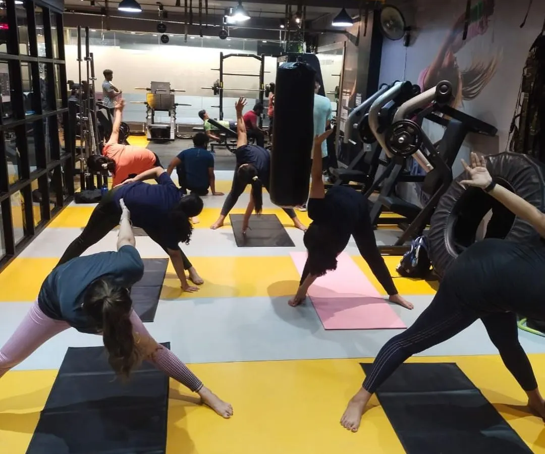 To balance the high-energy workouts, we offer yoga classes focused on flexibility, strength, and mindfulness. Here, our members are in a group yoga session, working on their form and finding their focus together.