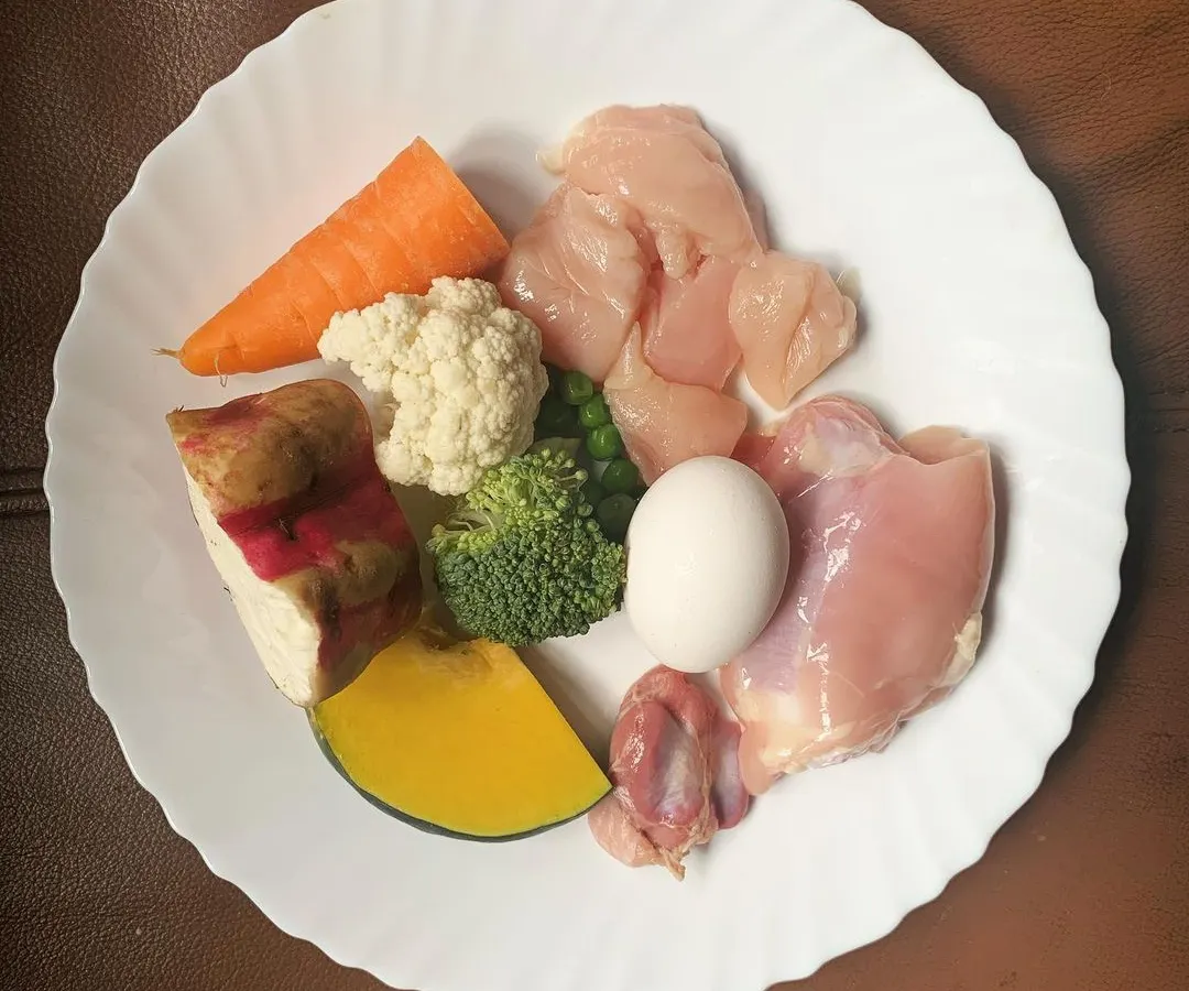 This is what I mean by real food. Fresh chicken, bright carrots, sweet potato, broccoli, and egg. If I wouldn't eat the ingredients, I wouldn't serve them to your dog.