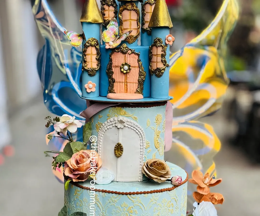 A fairytale brought to life. This multi-tiered princess castle cake features intricate, hand-sculpted details and kinetic butterfly wings that appear to flutter, creating a truly magical centerpiece for a grand celebration.