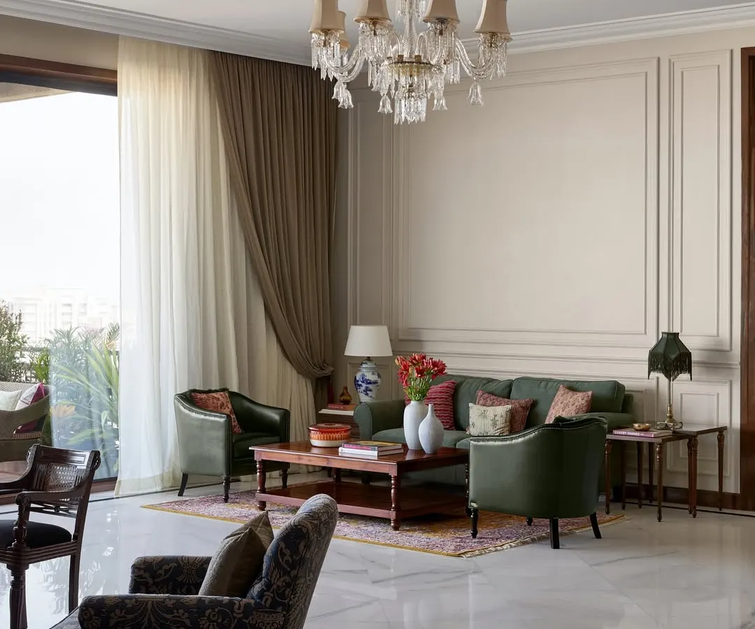 For the expansive central lounge at the new Maddock office, I chose to create several intimate seating areas instead of one large one. This approach encourages smaller, more personal conversations, turning a large hall into a series of warm, inviting corners for creative collaboration, all anchored by timeless wall paneling and a classic crystal chandelier.