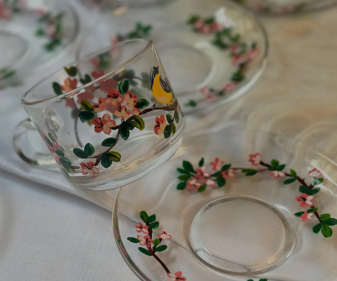 Your daily chai deserves a beautiful cup. I painted these delicate glass cups and saucers with a cherry blossom and bird design, perfect for making your tea time a little more special.