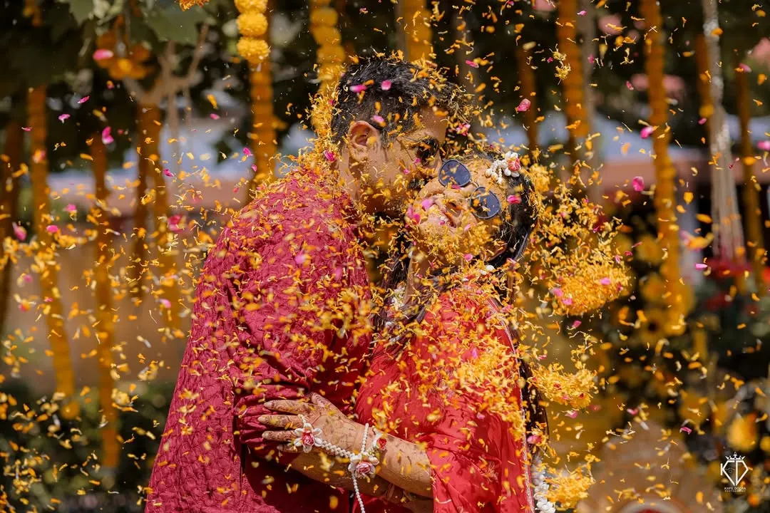 Haldi is all about pure, unadulterated joy. I love getting right into the middle of the celebration to capture moments like this one, a spontaneous kiss amidst a shower of marigold petals. These are the candid, colorful memories that you'll cherish forever.