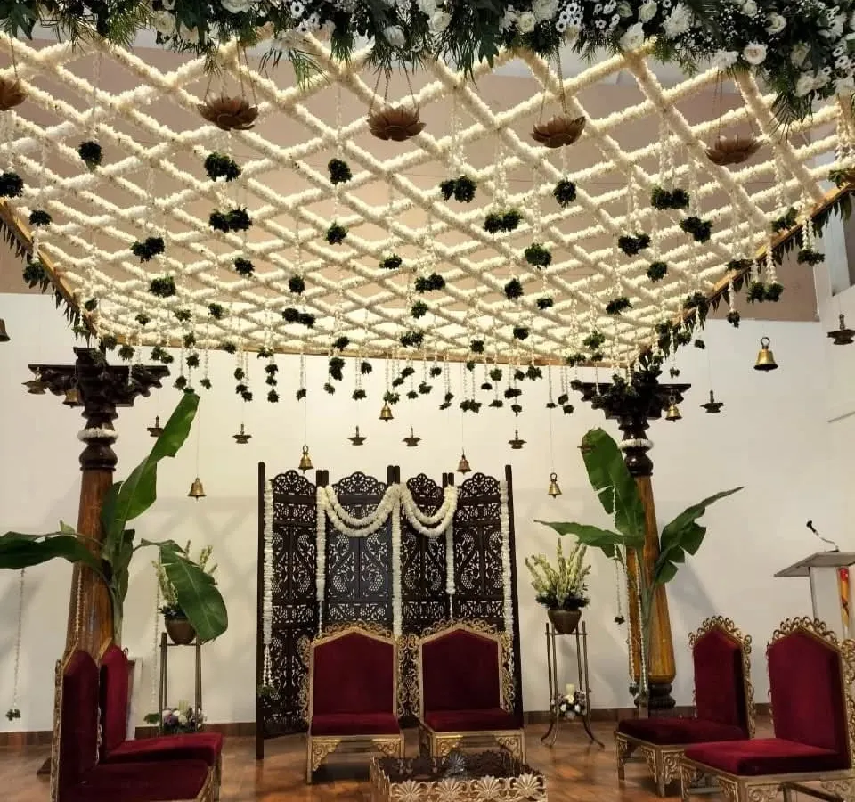 This traditional South Indian mandap showcases our expertise in intricate floral work. We created a stunning overhead lattice of fresh jasmine and tuberose, accented with hanging temple bells and banana leaf pillars, to craft a sacred and elegant ceremony space.