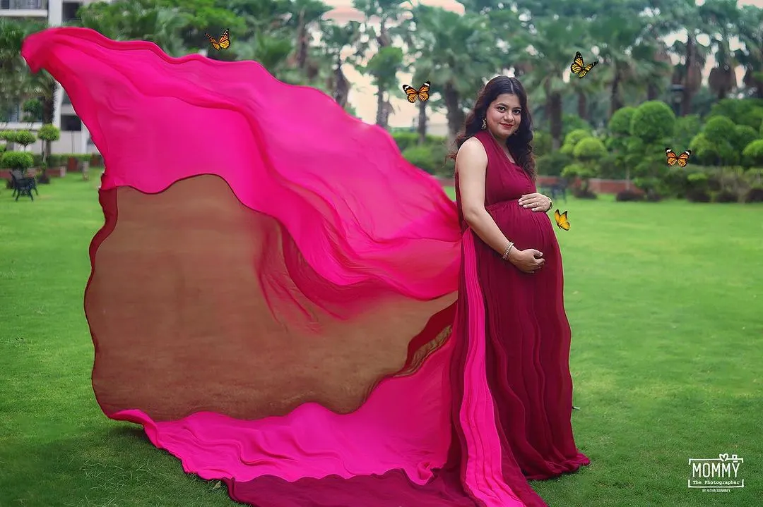 Let's create a fairytale moment for you. In this outdoor maternity photo, we used a flowing gown to create magical butterfly wings, celebrating the beautiful transformation of motherhood.