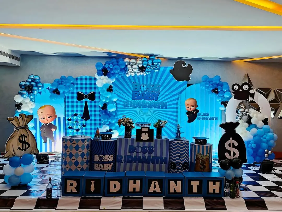 For a fun and stylish celebration, we designed this complete "Boss Baby" themed birthday for Ridhant. The setup includes a custom backdrop, character cutouts, themed plinths for the cake and desserts, and personalized name blocks, all tied together with a sharp blue, black, and white color scheme.