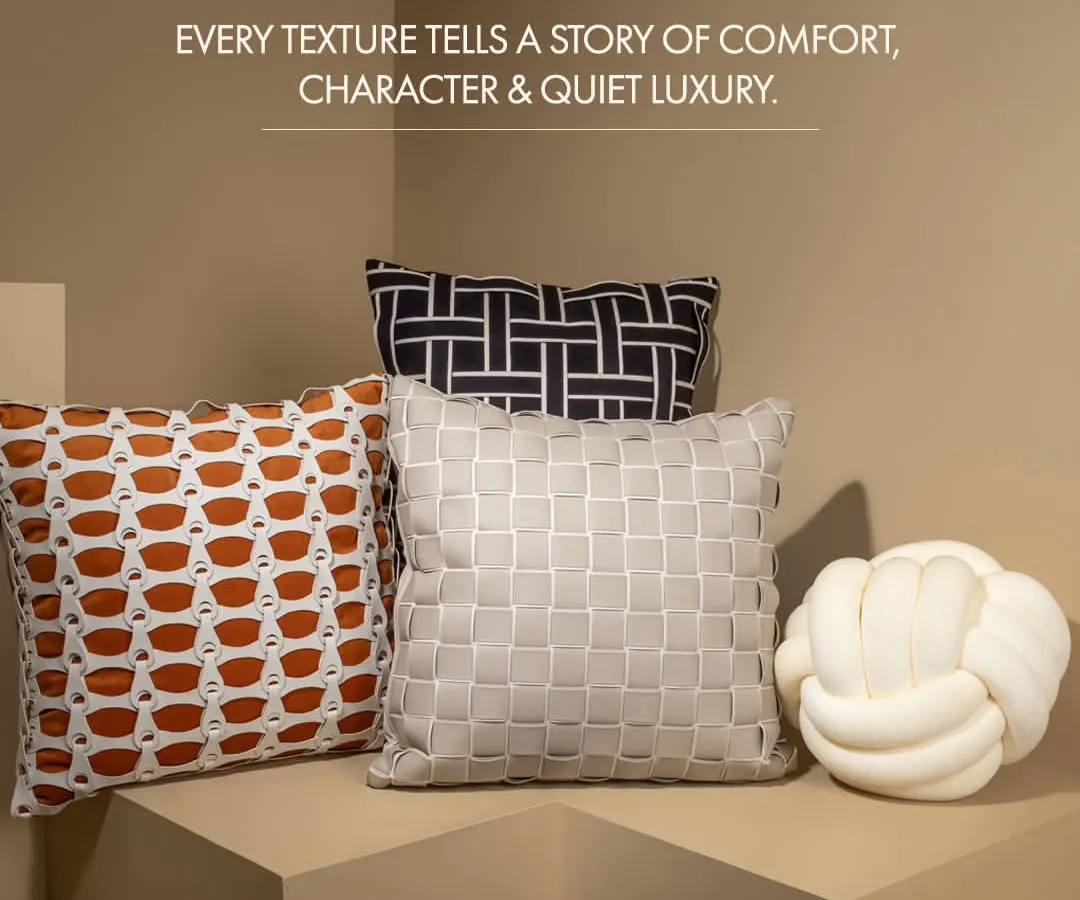 A home's comfort is in the details. This collection of designer cushions, featuring a knotted pillow and textured basket-weave covers, adds character and a touch of quiet luxury to any living space.