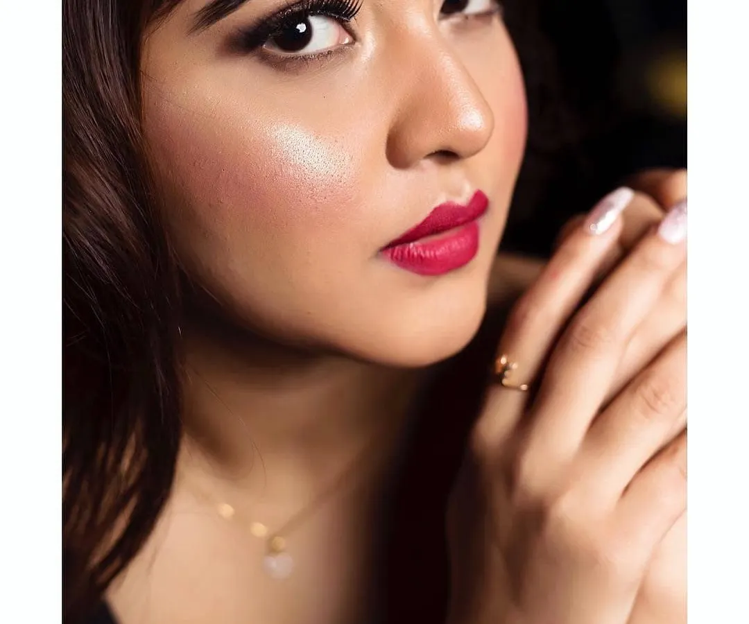 A close-up look at a classic party makeup style. I focused on creating a flawless, glowing complexion, sharp winged eyeliner, and a vibrant red lip. This detailed application ensures the makeup looks impeccable both in person and in photographs, making it ideal for any evening celebration.