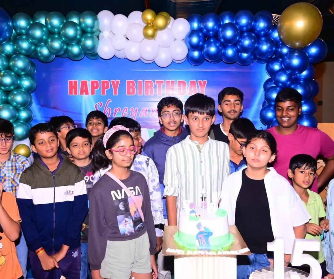 I also cover birthday parties for teenagers. This is a group photo from a 15th birthday celebration, capturing the birthday boy with his friends in front of a custom blue and gold balloon backdrop I set up for the event.