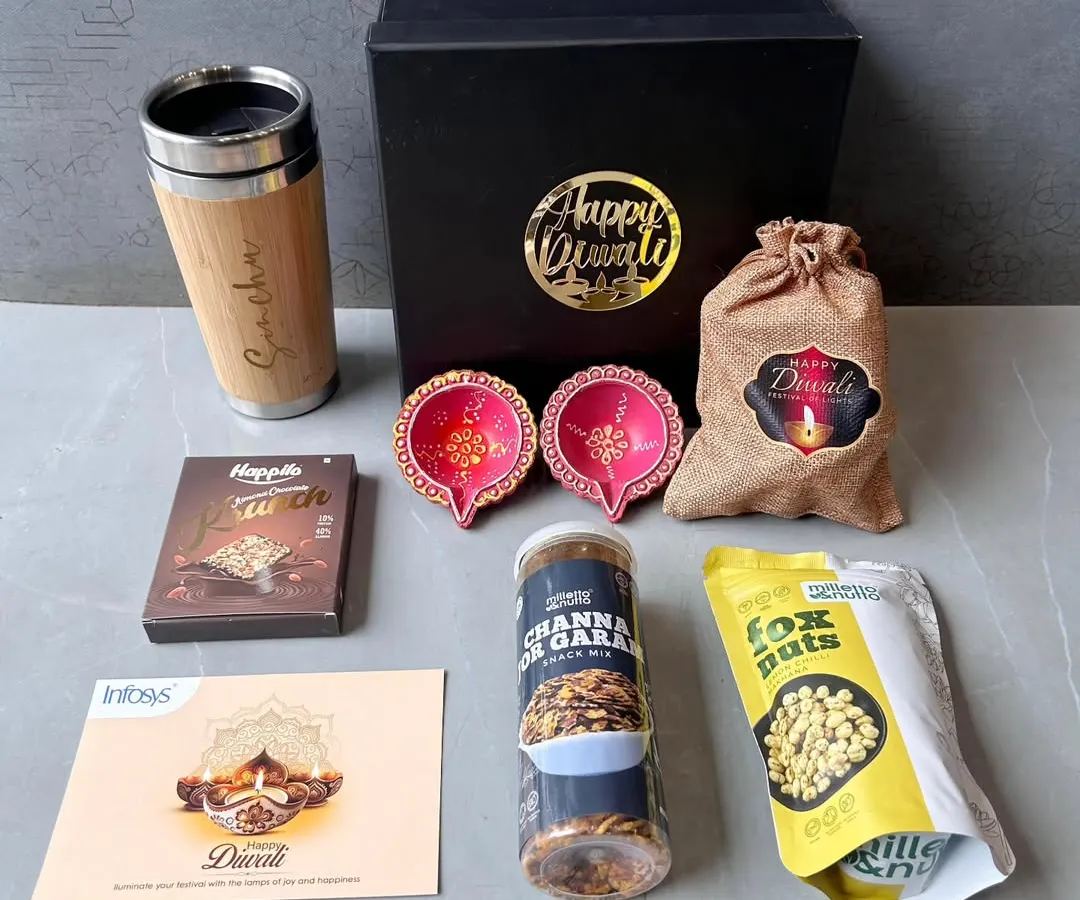 I also create custom hampers for festivals like Diwali. This set for Infosys combines a personalized bamboo travel mug with festive diyas, assorted snacks, and a branded greeting card, showing how we can mix practical items with seasonal treats.