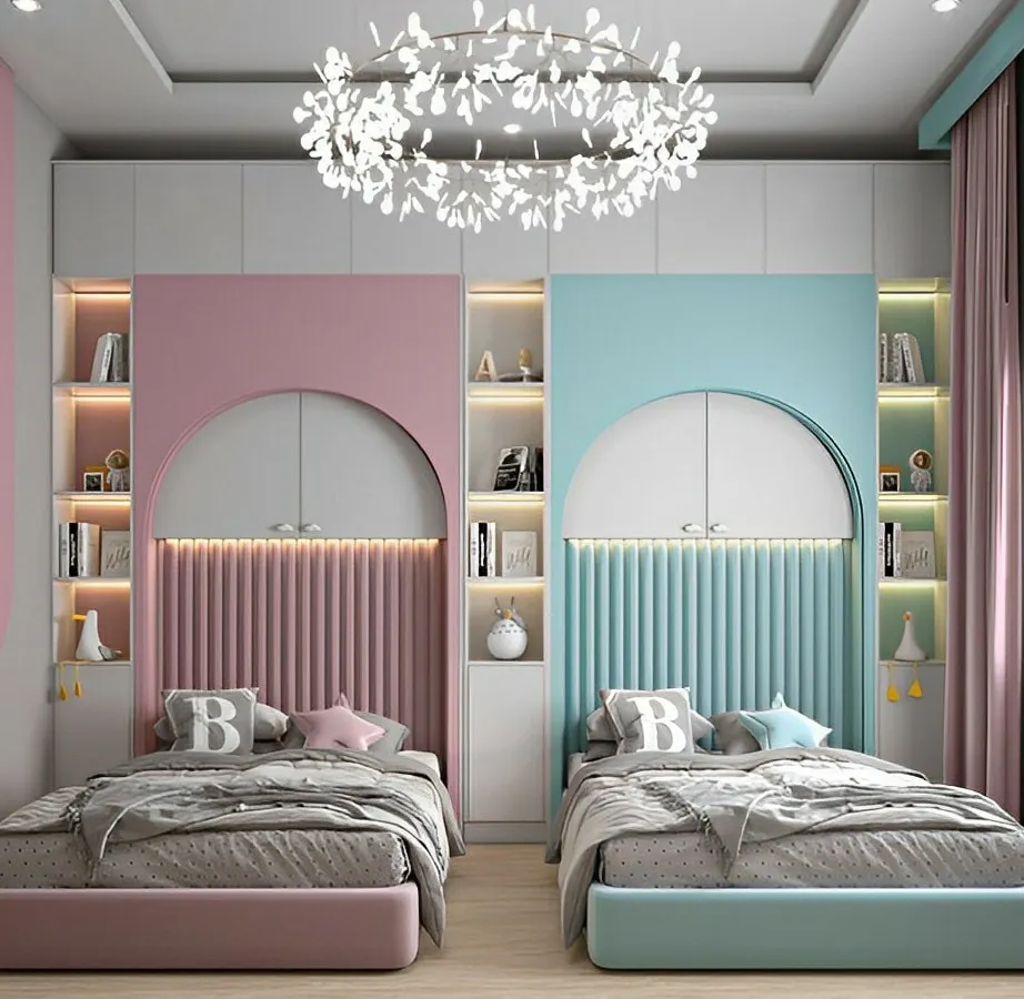 We designed this beautiful shared bedroom with a symmetrical layout to create a sense of harmony and personal space for two children. The design features custom arched headboards with fluted paneling, integrated shelving with ambient LED lighting, and a distinct color palette for each side, blending modern aesthetics with child-friendly personalization.