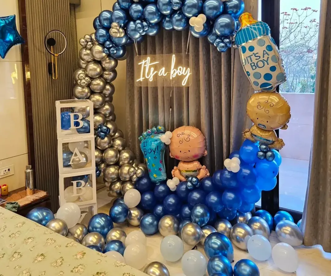 This is an example of my "It's a boy" baby shower decoration. I used a blue and silver chrome balloon arch, transparent "BABY" boxes, and special foil balloons to create a full and festive look for the celebration.