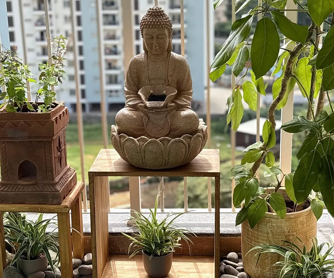 I can help you create a zen corner on your balcony, a perfect escape from the city buzz. This setup features a calming Buddha water fountain, hardy plants that love the sun, and natural stone details, all coming together to create a truly serene atmosphere.