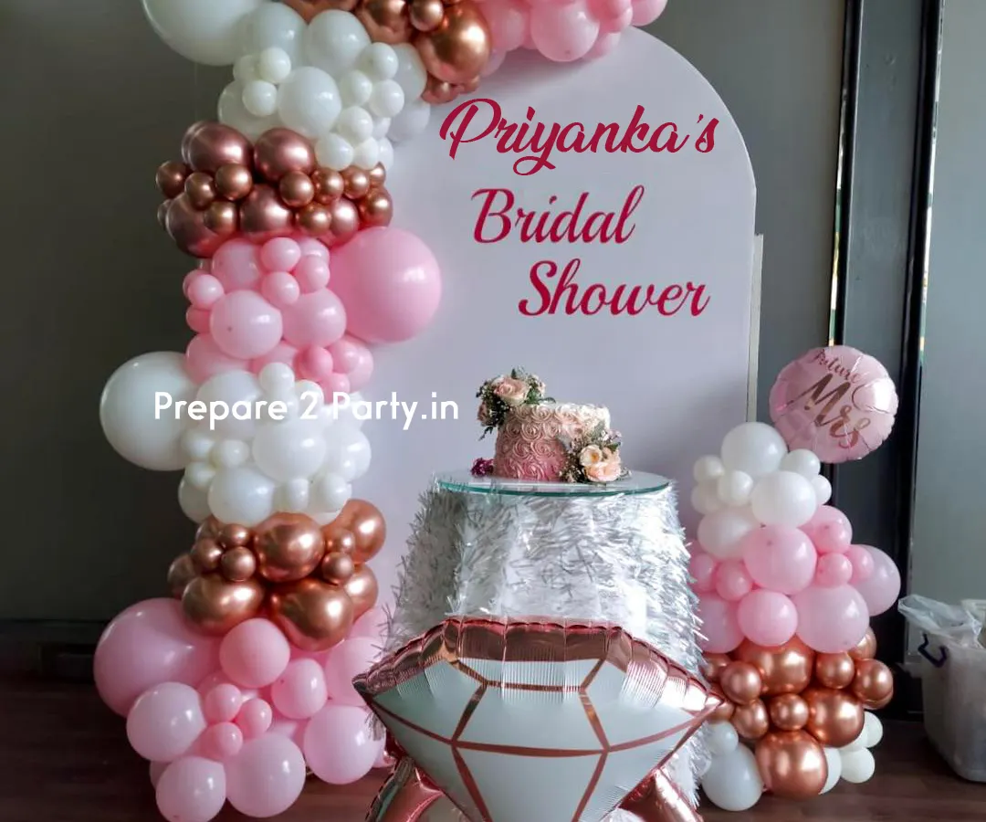 This is our classic bridal shower decoration, perfect for creating a feminine and celebratory atmosphere. The design includes a personalized arched backdrop, an organic balloon garland in pink, white, and rose gold, and a large diamond ring foil balloon for that perfect photo opportunity.