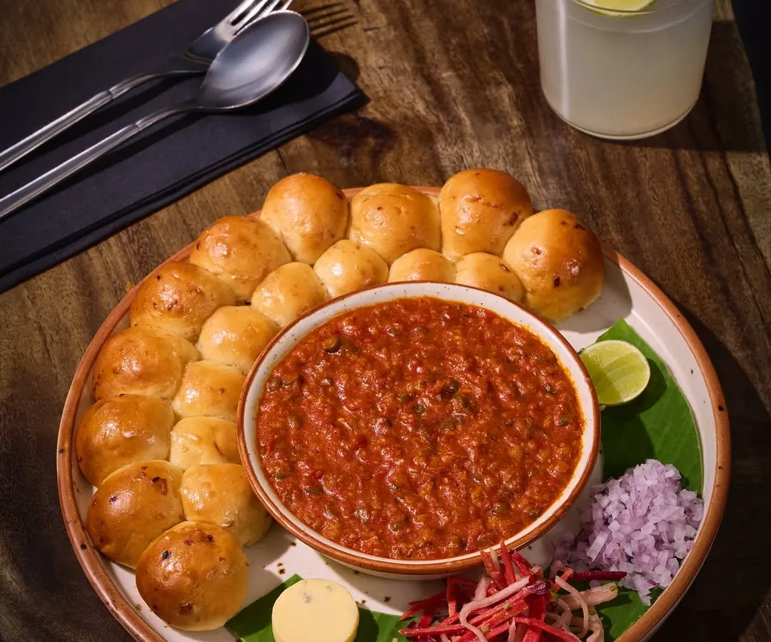 This is my take on a Mumbai icon, the Pav Bhaji. I serve it with a ring of soft, oven-fresh buttered paos, a rich and deeply spiced bhaji, and a dollop of herb butter. It’s a crowd favourite for a reason.