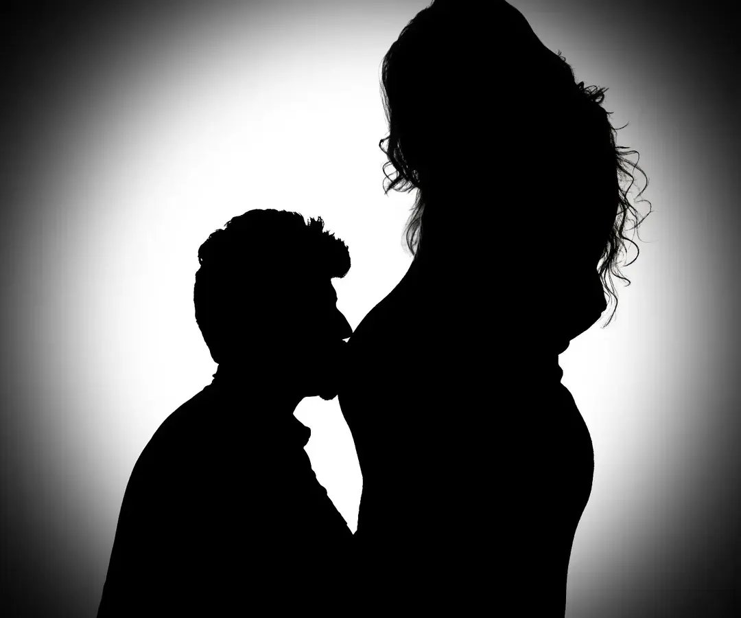 A dramatic silhouette captures the profound connection between partners. In this black and white portrait, the focus is purely on the emotion and the beautiful shape of new life, a powerful memory for you to hold onto.