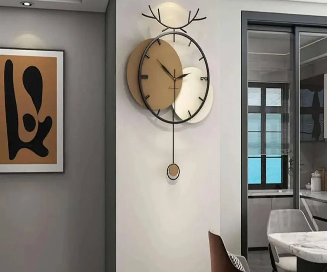 We combine modern art with functionality in this unique pendulum wall clock. Featuring a striking deer antler motif and contrasting metallic discs, it serves as both a reliable timepiece and a captivating piece of wall sculpture for any contemporary home.
