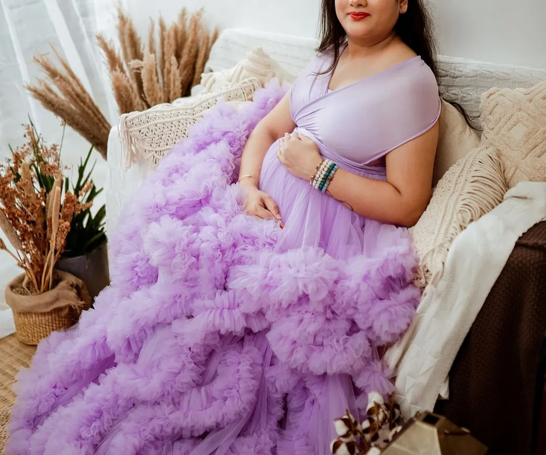 Our studio wardrobe features stunning pieces like this lavender ruffled gown that adds so much drama and elegance. We styled this shot in our Jayanagar studio with a boho-chic setup to create a warm, inviting atmosphere for this beautiful mom-to-be.