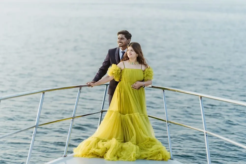 Create your own fairytale moment with a photoshoot on a yacht. This couple showcases our vibrant yellow tiered gown, a perfect choice for a pre-wedding shoot that is both romantic and unforgettable. I help you get these amazing shots with my collection of statement gowns.