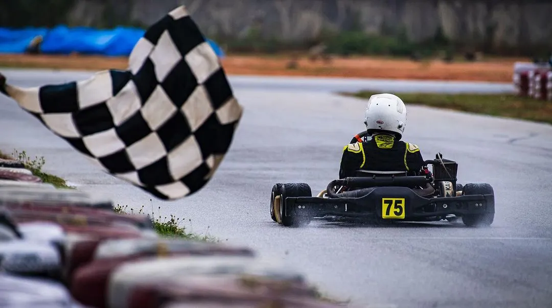 The moment every driver dreams of: crossing the finish line to the checkered flag. This shot from the Meco Meritus Cup captures the culmination of a weekend of intense racing, strategy, and pure determination.